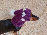 Knitted clothes dog hat with hearts for valentine's day