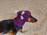 Knitted clothes dog hat with hearts for valentine's day