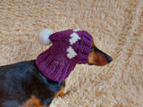 Knitted clothes dog hat with hearts for valentine's day