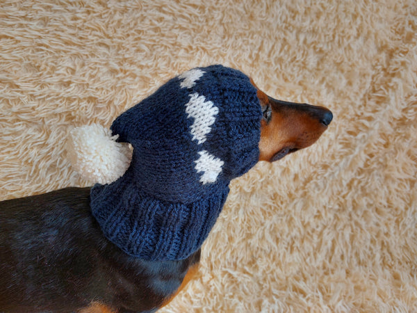 Knitted clothes dog hat with hearts for valentine's day