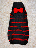 Black dog sweater with red stripes and a bow
