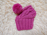 Warm winter snood hat for a dog with a pom-pom