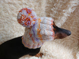 Warm winter snood hat for a dog with a pom-pom dachshundknit